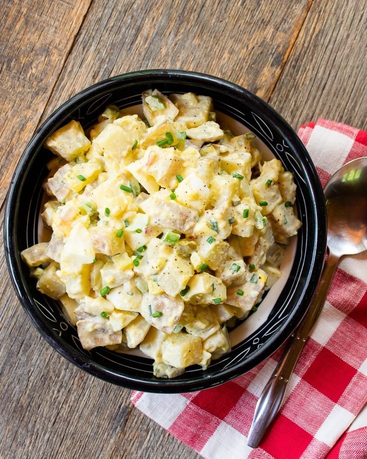 Classic Potato Salad with tender potatoes, chopped celery, and onions, topped with a creamy dressing